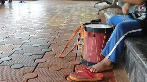 Boy making sound over a drum Stock Footage 137791567