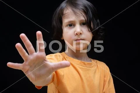 Boy making stop gesture as restriction, prohibition and children concept Stock Photos