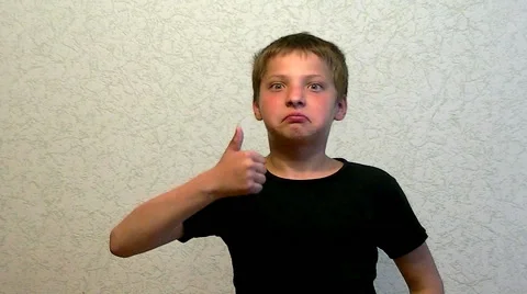 Boy making a surprised face  and thumb up Stock Footage 63635457