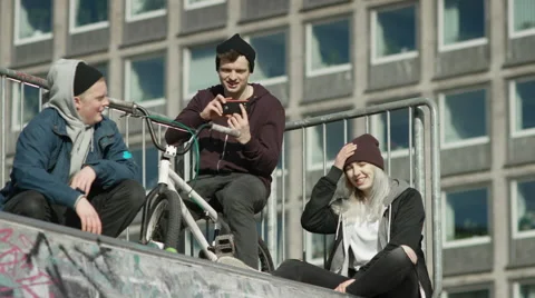 Boy making video of a skater performing tricks Stock Footage 61750801