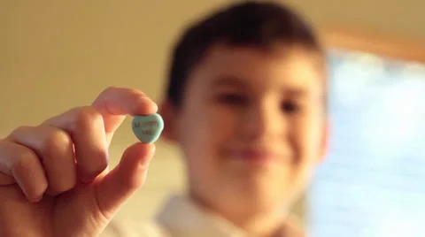 Boy with "Marry Me" Candy - Rack Focus Stock Footage 34260998