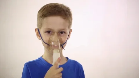 The boy in the mask the inhaler is treated Stock Footage 79841674