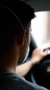 Boy in a mask while driving. Фото