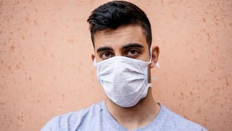 Boy with a mask on while he's staring straight ahead. Фото