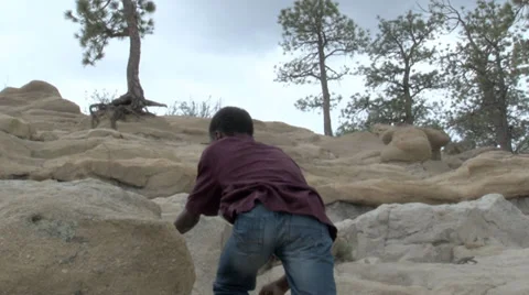 Boy meandering up rock formation. Video stock 27341035