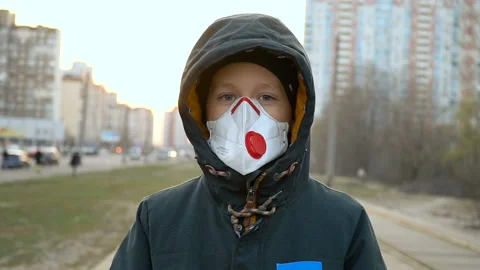 Boy in a medical mask on the street Video stock 127629341