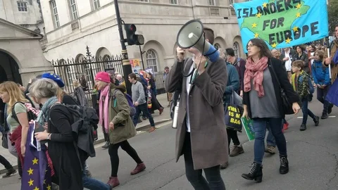 Boy with megaphone as protesters marching against Brexit deal Stock Footage 118276651