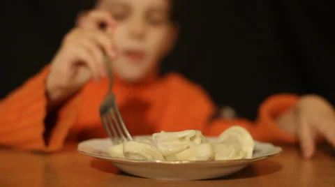 Boy, a microphoneboy eats pelmeni Stock Footage 905902