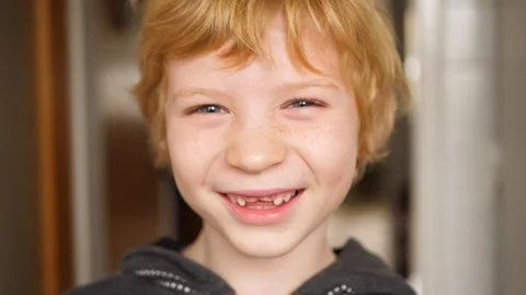 Boy with milk tooth gap laughs wonderfully at the camera 스톡 동영상 121696019