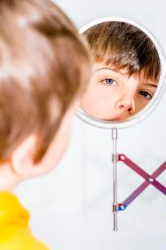 Boy in mirror Stock Photos