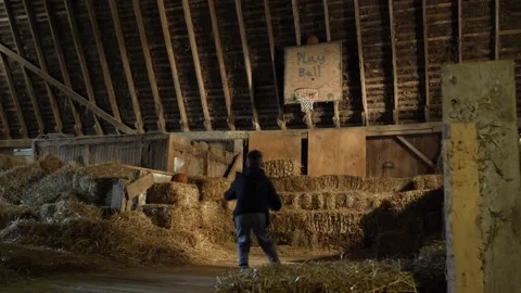 Boy Missing a Basketball Jumpshot in a Barn 스톡 동영상 148331034