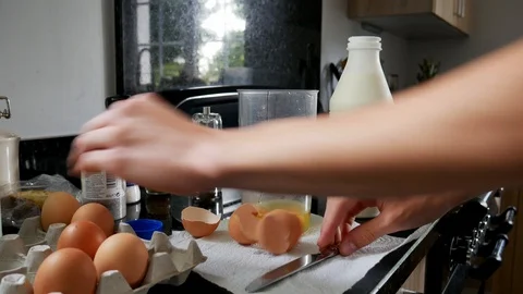 Boy mixing eggs for scrambled eggs or omelet Stock Footage 111353120