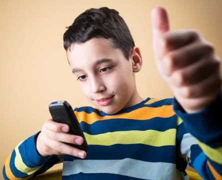 Boy with mobile phone Stock Photos