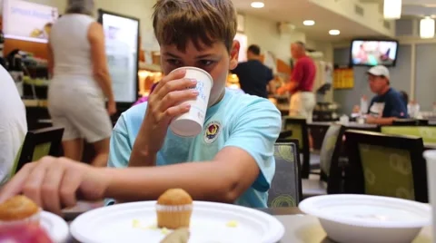 Boy (model with release) drinks coffee in Papa Palheta. Stock Footage 57176178