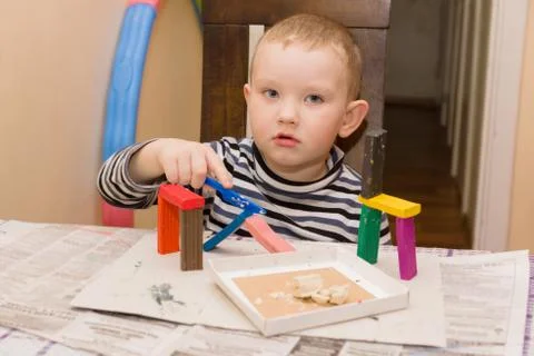 The boy molds plasticine Stock Photos
