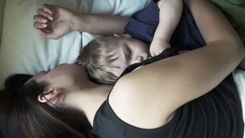 Boy with mom lie on a shelf 스톡 동영상 133890394