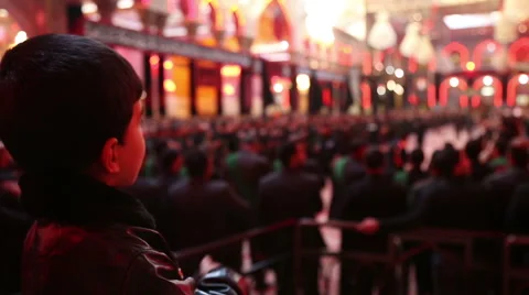 Boy mourning for Imam Hussein inside Hussein's shrine, Karbala, Iraq 757 Stock Footage 45158970
