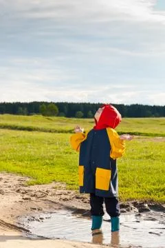 Boy in a muddy puddle Foto stock