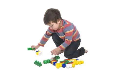 Boy with multicolored bricks Stock Photos