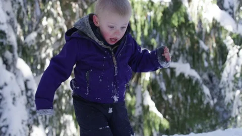 Boy Navigating Deep Snow Looking - 4k - Slow motion Video stock 70150652