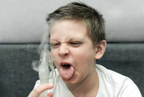 A boy with a nebulizer 2 Stock Photos