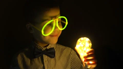 Boy with neon glasses and a light bulb 4K Stock Footage 101492344