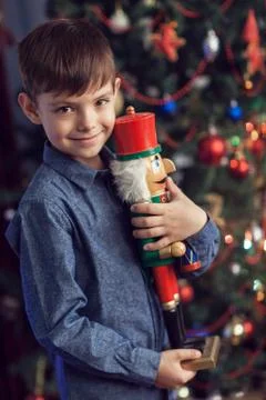 A boy at a New Year tree with a nutcracker Stock Photos