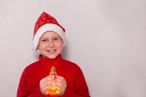 Boy in a New Year's hat with a magic lamp Stock Photos