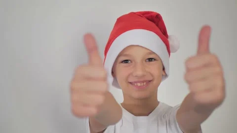 A boy in a New Year's hat shows a finger up Stock Footage 223397596
