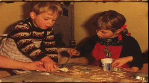 Boy nibbling while making Cristmas cookies (vintage 8 mm amateur film) Stock Footage 879347
