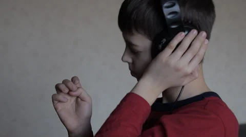Boy is nodding to the beat 스톡 동영상 65408170