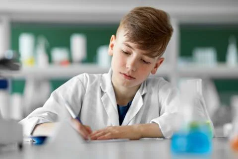 Boy with notebook studying biology at school Stock Photos