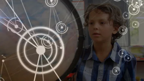 Boy noticing animated concentric circles overlaying gong in class, tilting head Stock Footage 316185639