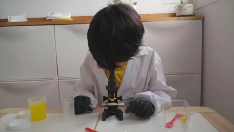 Boy observing through microscope Stock Footage 280684871