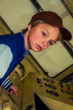 Boy in an old control room of a train Stock Photos