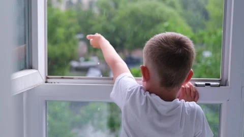 The boy opened the window and held out her hand. Stock-Footage 246500432