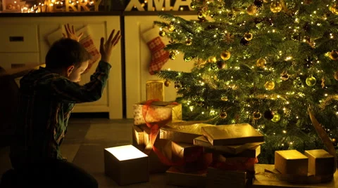 Boy opening christmas present surprised Stock Footage 58729946
