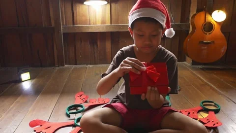 A boy opening a gift box on christmas day Stock Footage 142038720