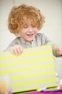 Boy opening his birthday present Stock Photos