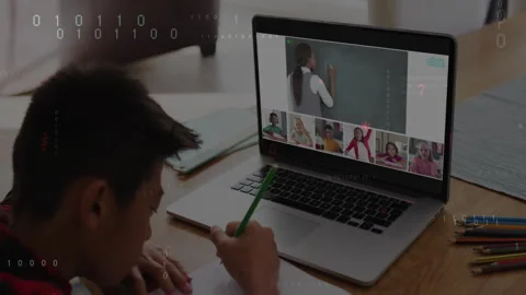 Boy opening laptop and joining online coding lesson while copying notes and Stock Footage 312280185