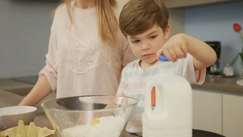 Boy opening a milk bottle Stock-Footage 100000643