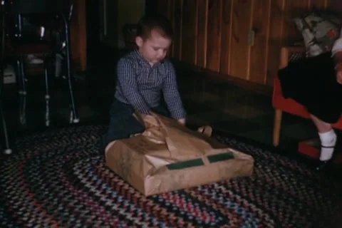 Boy opening present  a  farm set Stock Footage 24741009
