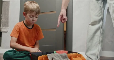 Boy opens and closes metal pliers exploring tool mechanics Stock Footage 323969024