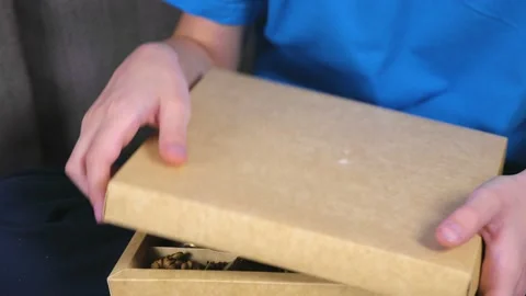 Boy opens a box of chocolate candies and eat cocolates. Close-up chocolates. Stock Footage 101604685