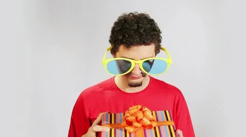 Boy opens a box with a gift Stock Footage 11007445