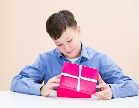 The boy opens a box of surprise Stock Photos