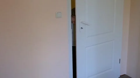 Boy opens the door in the room Stock Footage 240186858