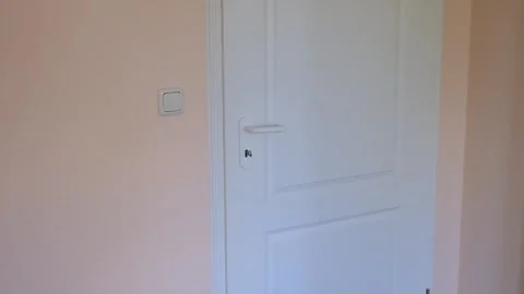 Boy opens the door in the room Stock Footage 240186865