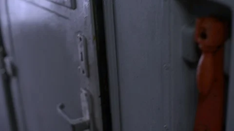 Boy opens door to train,smiles at the camera,and leaves through another door Stock Footage 128241547