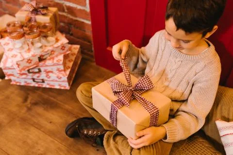 The boy opens a gift Stock Photos